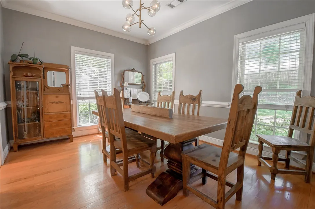 This inviting dining room offers abundant natural light and rich hardwood floors.