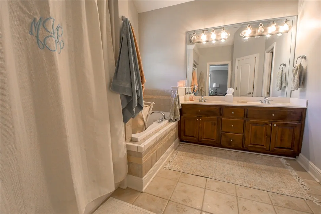 This bathroom features a double vanity and soaking tub, offering a relaxing retreat.