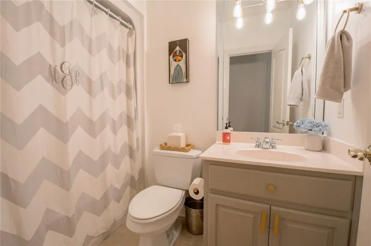 This bright bathroom features a spacious vanity and a clean, functional layout.