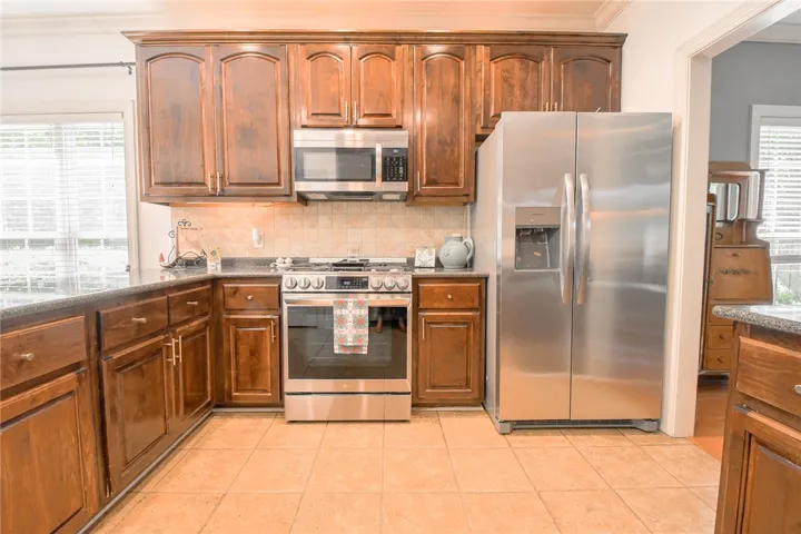 This spacious kitchen offers ample cabinetry and modern appliances, perfect for daily living.