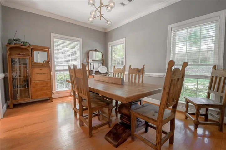 This inviting dining room offers abundant natural light and rich hardwood floors.