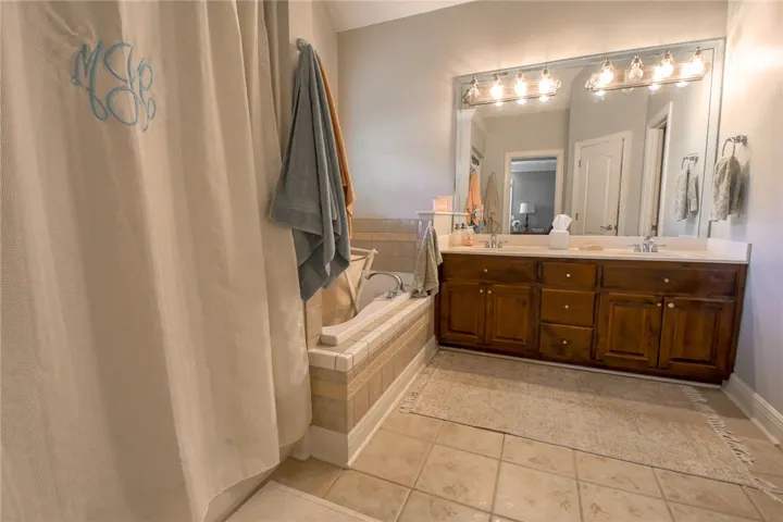 This bathroom features a double vanity and soaking tub, offering a relaxing retreat.