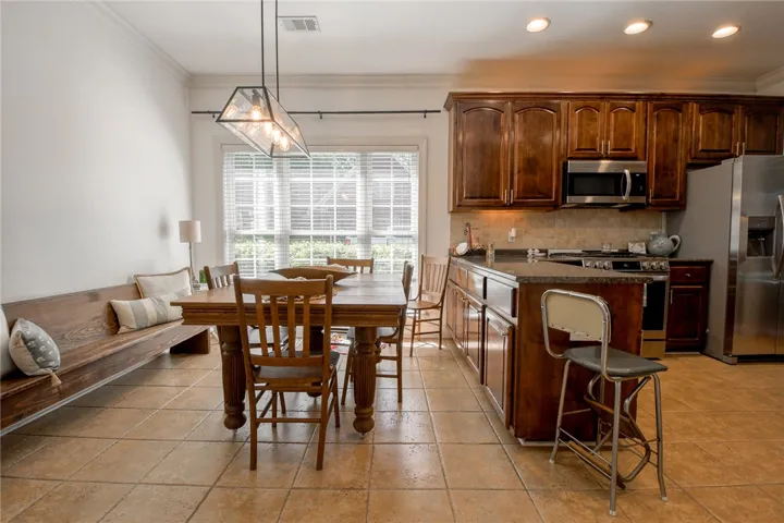 This spacious eat-in kitchen features rich cabinetry and modern appliances, perfect for everyday living.