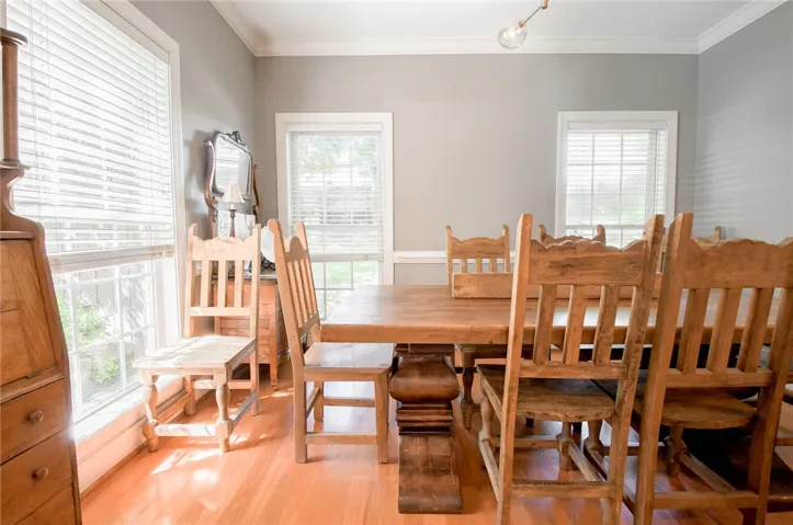 This inviting dining room offers abundant natural light and hardwood floors.