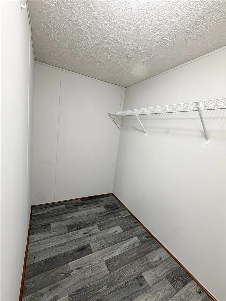 This spacious closet features ample storage solutions and durable flooring.