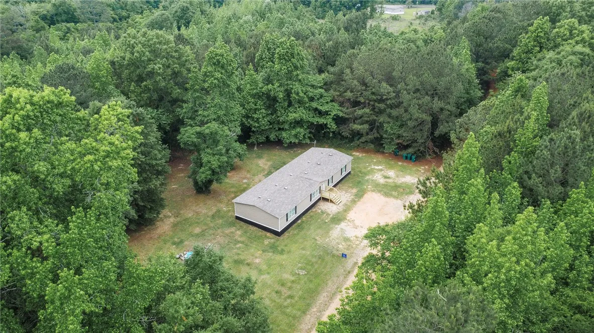Secluded residence nestled amidst a vibrant canopy of mature trees, offering tranquil living.