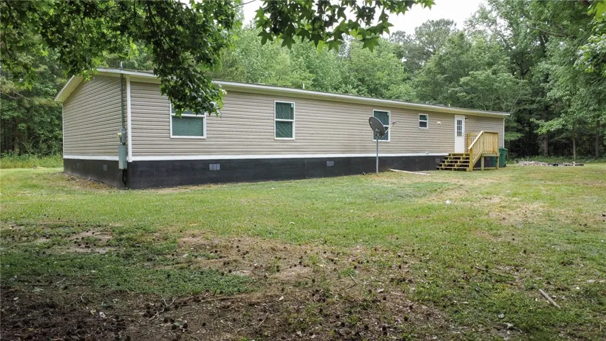This residence offers a tranquil retreat surrounded by mature trees and natural scenery.