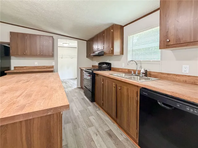This spacious kitchen offers ample cabinet storage and convenient appliances.