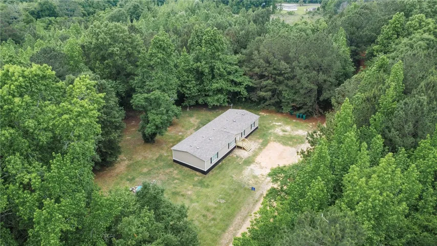Secluded residence nestled amidst a vibrant canopy of mature trees, offering tranquil living.
