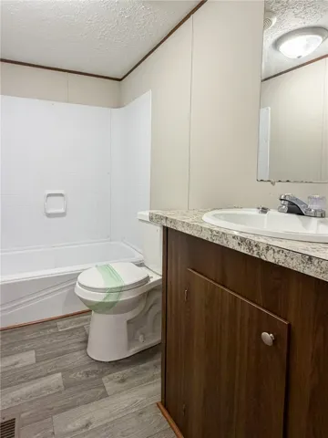 This clean bathroom features practical design and a comfortable ambiance for everyday routines.