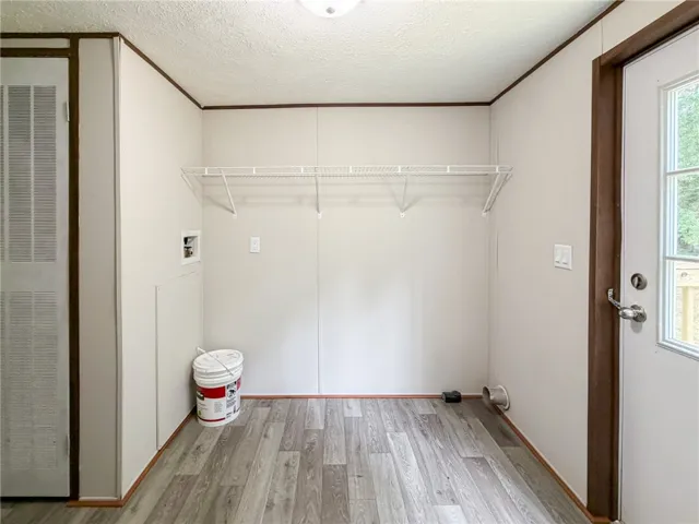 This spacious utility area offers ample room for laundry essentials.