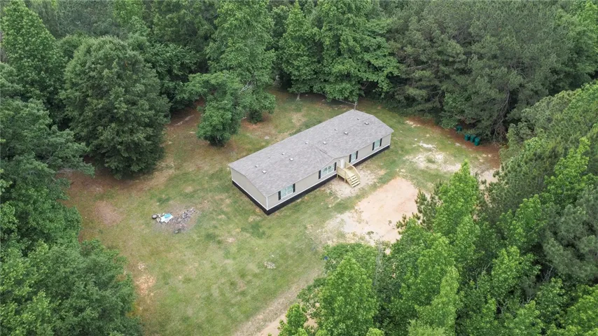 This tranquil woodland setting presents a welcoming, spacious residence.