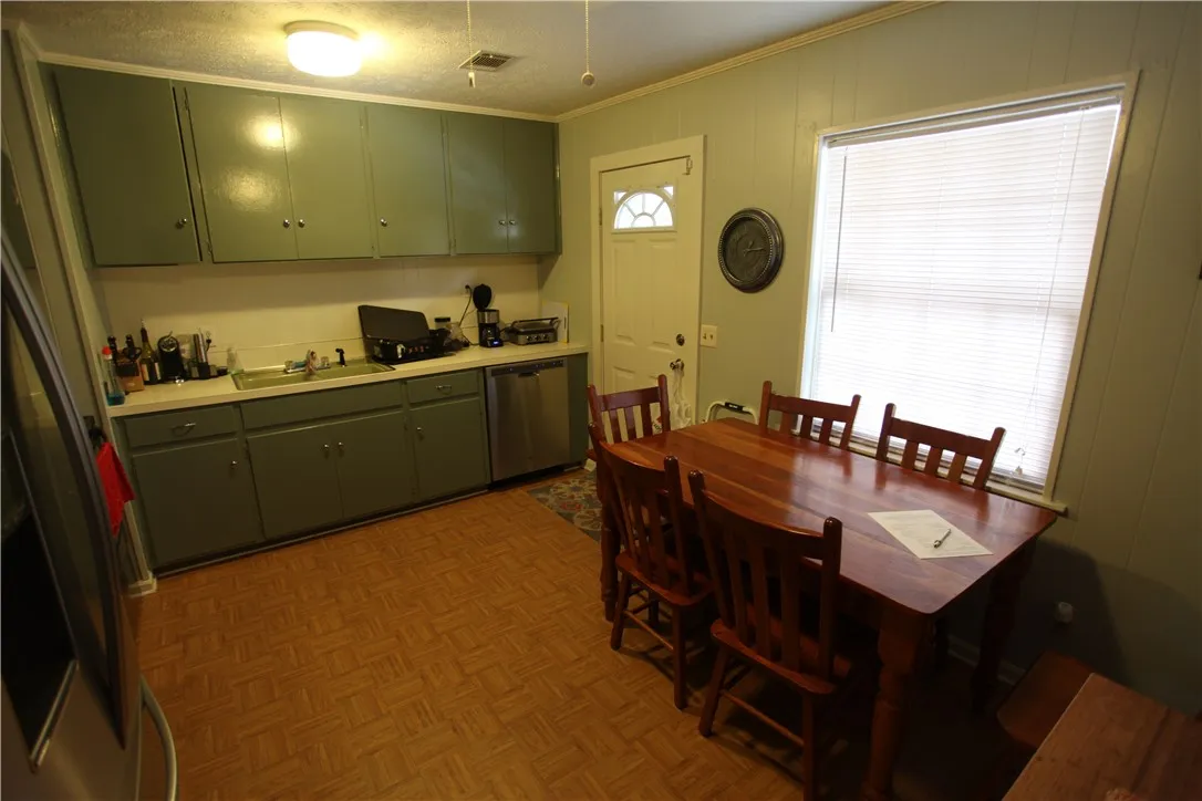 This cozy kitchen features functional appliances and a bright window, perfect for casual dining.