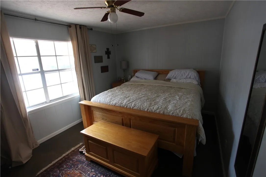 This cozy bedroom offers a tranquil retreat with ample natural light.
