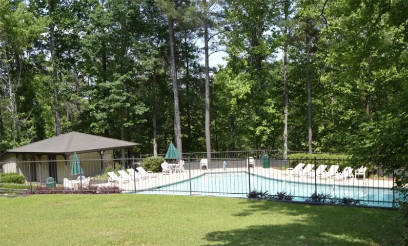 This serene outdoor oasis features a sparkling pool, inviting for relaxation and leisure.
