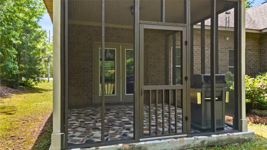 This inviting screened porch provides a perfect outdoor living space.