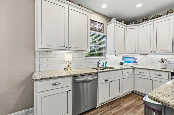 This bright kitchen features ample cabinetry and beautiful countertops, perfect for culinary endeavors.