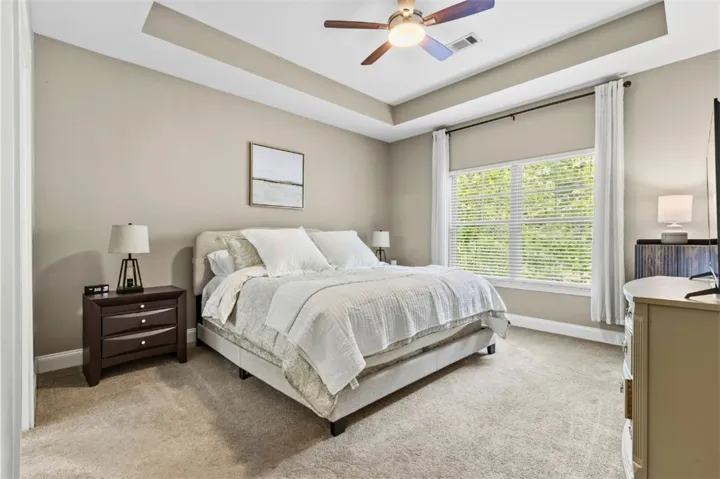 This restful bedroom offers a spacious retreat with natural light and elegant finishes.