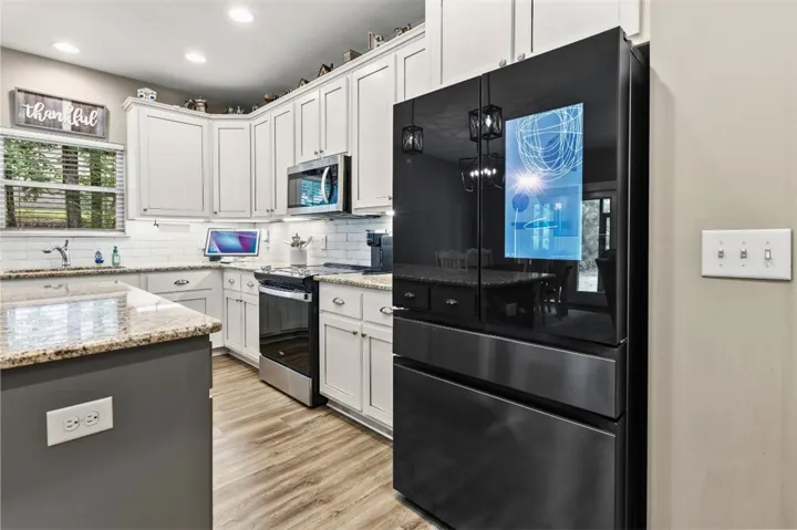 This spacious kitchen combines modern appliances with classic finishes, perfect for daily living and entertaining.