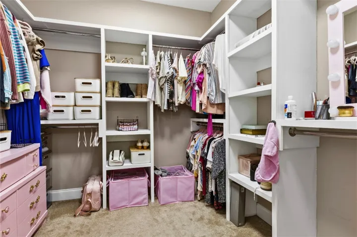 This spacious walk-in closet offers ample storage and efficient organization for any wardrobe.