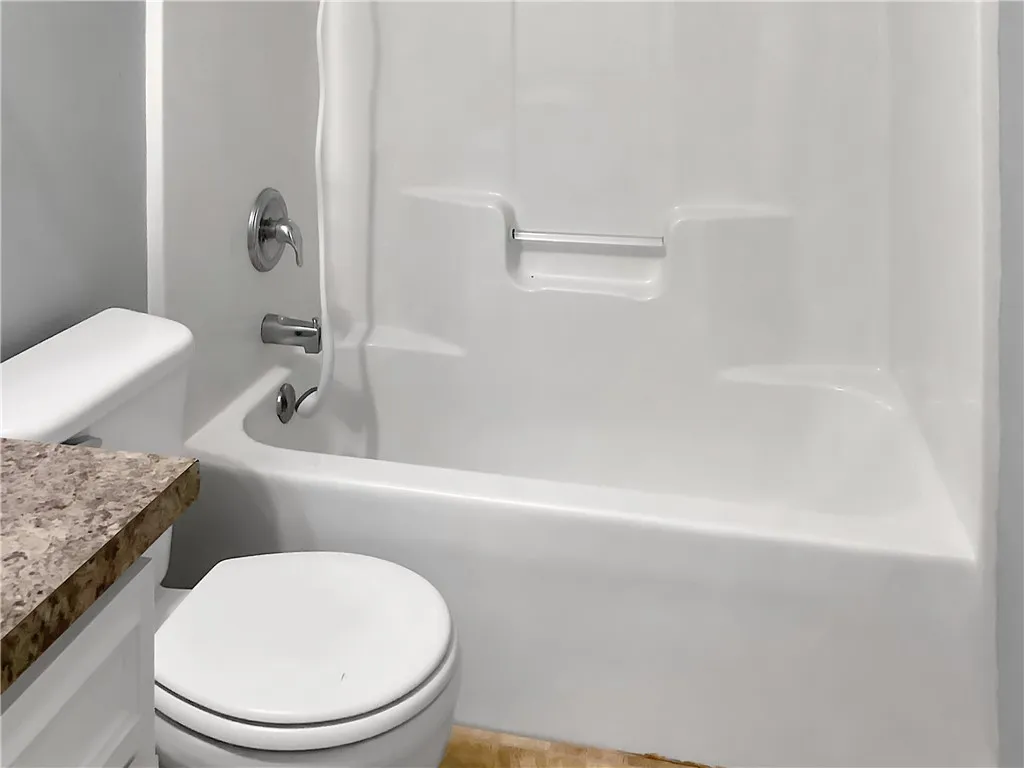 A well-maintained tub and shower combination with clean fixtures offers a refreshing start to your day.