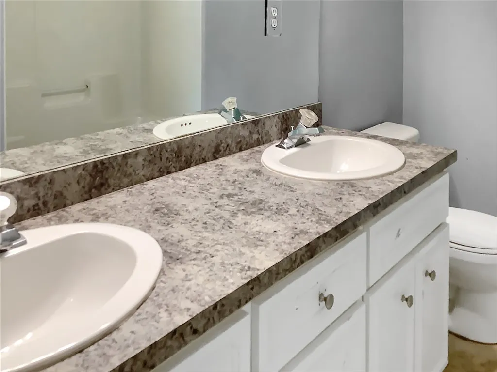 Double vanity with ample counter space offers functional elegance in this bathroom.