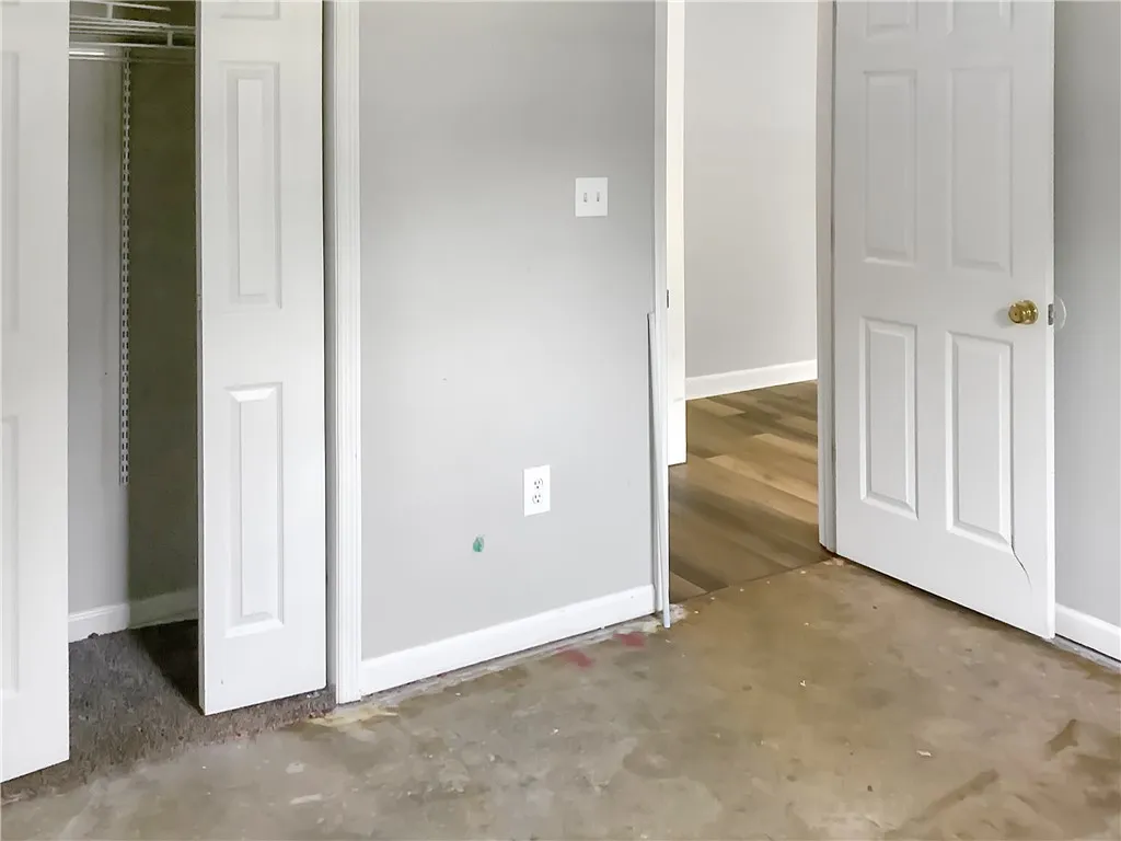 A versatile space awaiting your personal touch, featuring a functional closet and connecting doorway to adjacent areas.