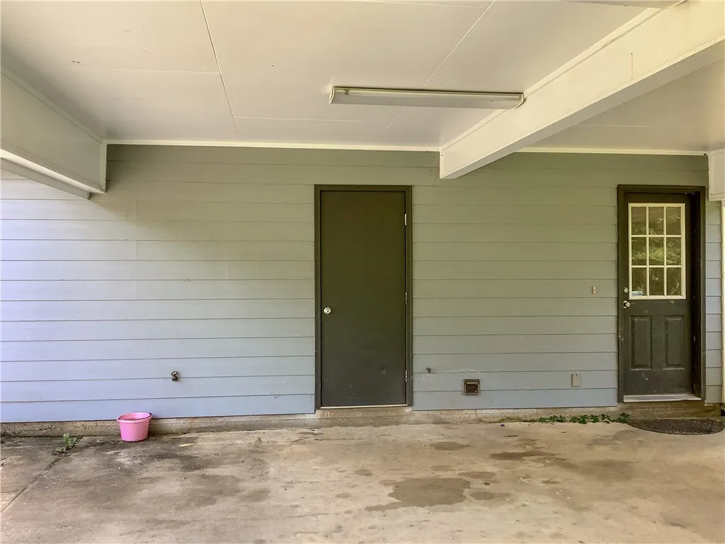 A durable concrete patio offers convenient outdoor access with two entry doors.
