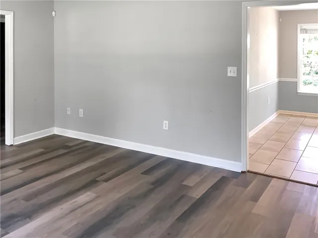 Clean lines and a spacious layout create a versatile living area with dual flooring types.