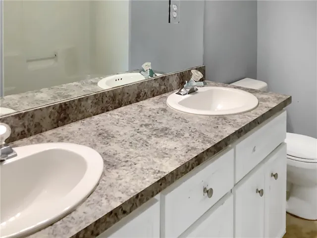 Double vanity with ample counter space offers functional elegance in this bathroom.