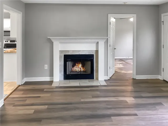 A comforting fireplace hearth centers this adaptable living space with resilient flooring.