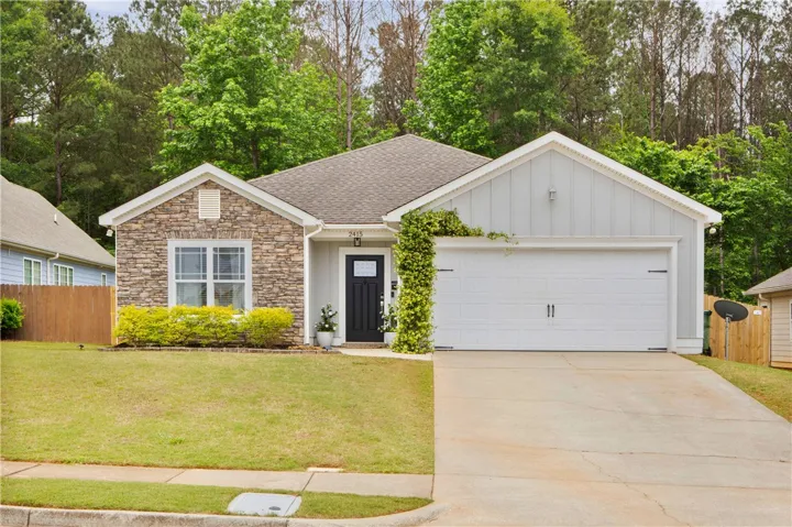 This charming home offers a perfect blend of natural stone and classic siding.