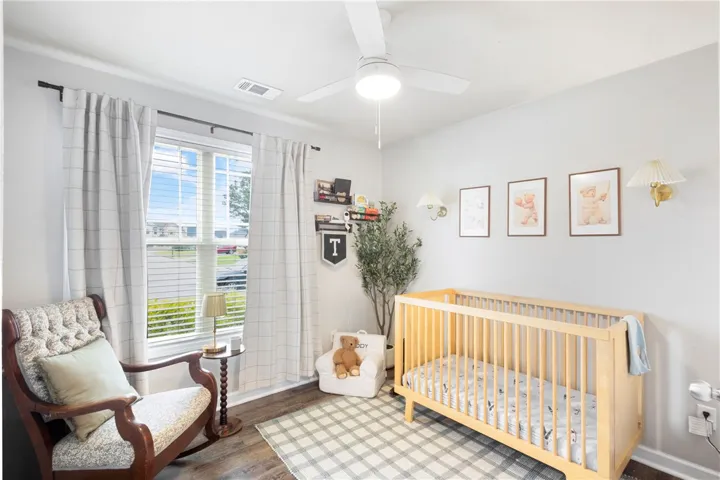 This bright and inviting bedroom offers a serene retreat with ample natural light.
