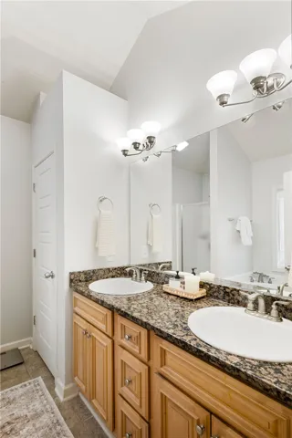 This spacious bathroom offers dual vanities with ample counter space and storage.
