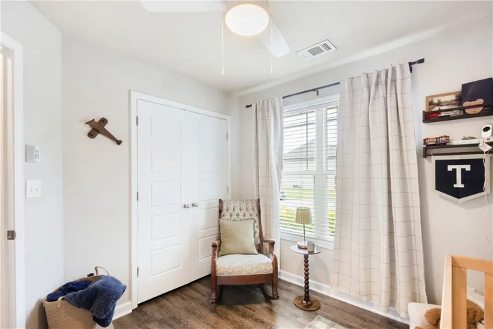 This cozy bedroom features durable flooring and ample natural light, creating a bright and inviting atmosphere.