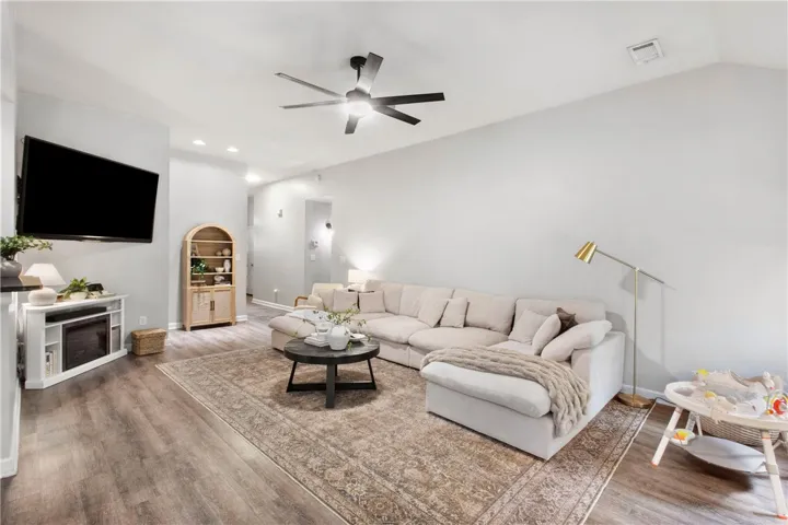 This inviting living room features elegant wood flooring, providing a warm and welcoming ambiance.