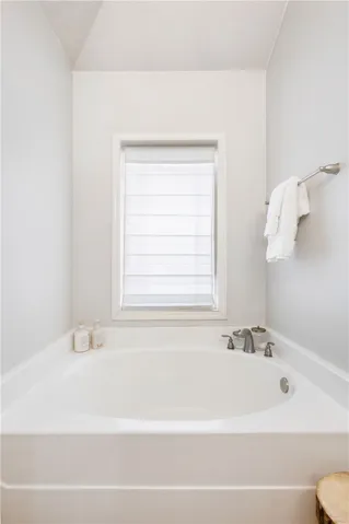 This private bathroom offers a deep soaking tub, perfect for unwinding after a long day.