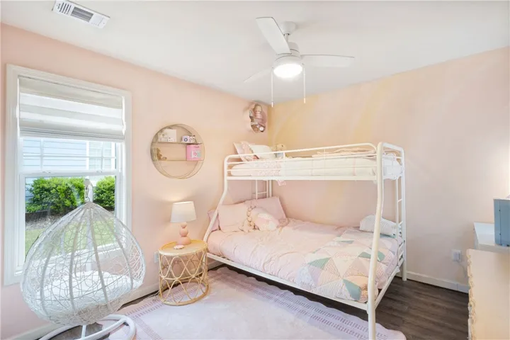 This cozy bedroom features durable flooring and ample natural light, perfect for restful living.