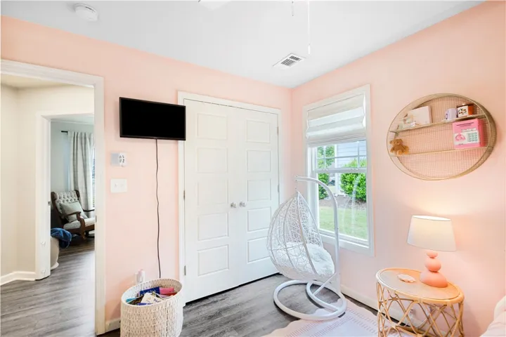 This cozy bedroom features durable flooring and ample natural light, perfect for restful living.