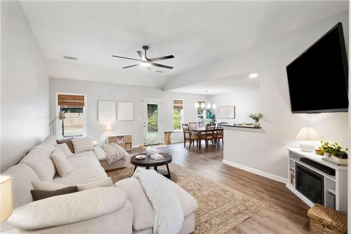 This bright living space seamlessly transitions to a dining area and outdoor access, ideal for gatherings.