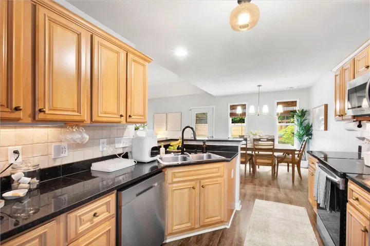 This bright kitchen features ample cabinetry and a functional layout, seamlessly flowing into the dining area.