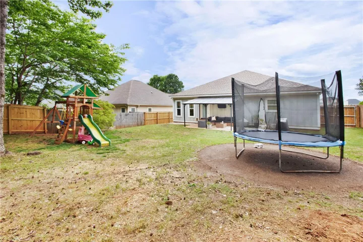 This spacious private yard offers abundant outdoor living with a covered patio.
