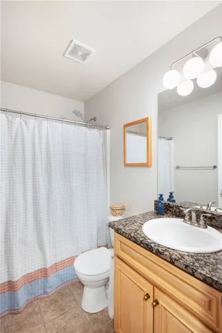 This bathroom features a sleek vanity, modern fixtures, and ample lighting.