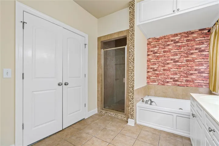 Relax in this well-appointed bathroom featuring a soaking tub and walk-in shower.