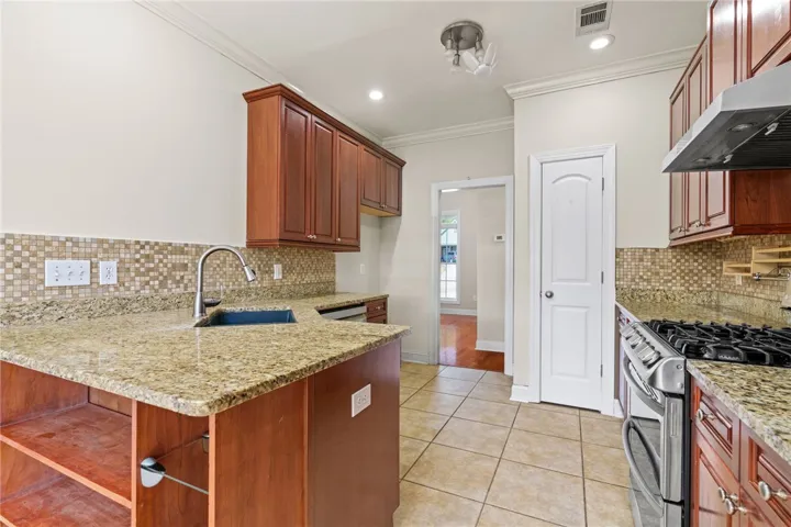 Gleaming granite countertops and rich wood cabinetry define this well-appointed kitchen.