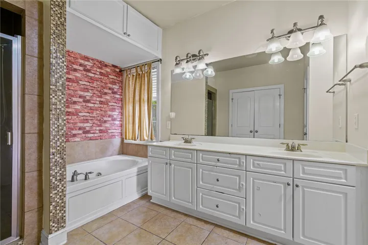 Dual vanities and a deep soaking tub create a luxurious primary bathroom retreat.