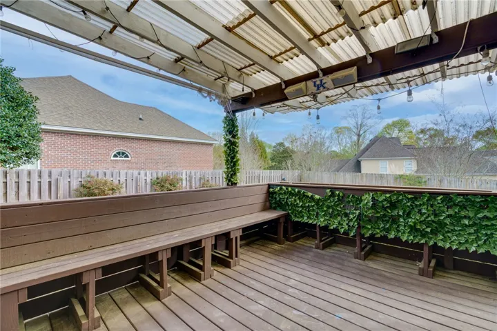 A spacious outdoor deck with built-in seating offers ample room for alfresco entertaining.
