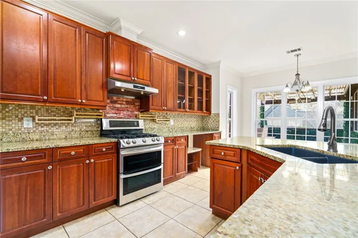 Culinary aspirations find their home in this well-appointed kitchen featuring granite countertops and stainless steel appliances.