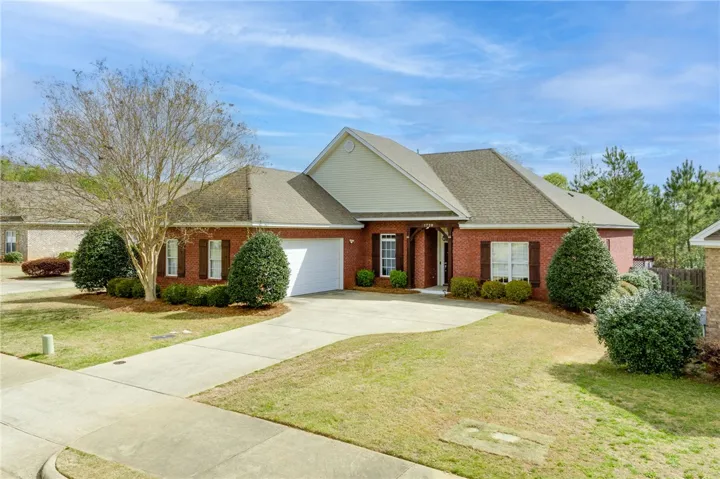 A classic brick exterior with well-maintained landscaping and a spacious driveway welcomes you home.