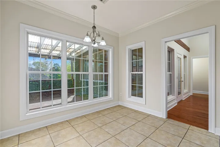 A sun-filled room boasts expansive windows, inviting natural light and scenic views inside.